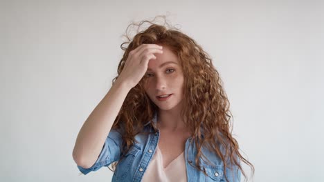 tudio shot video of red hair young woman  with big hair