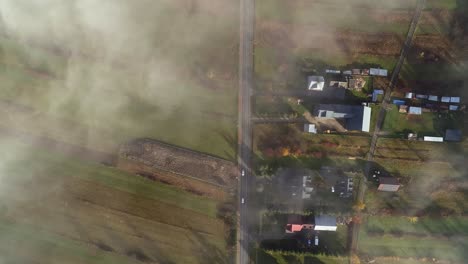 Magical-mist-above-rural-village-of-Chochołów-in-Poland,-top-down-aerial