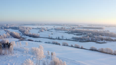 flying over a calm rural landscape in winter