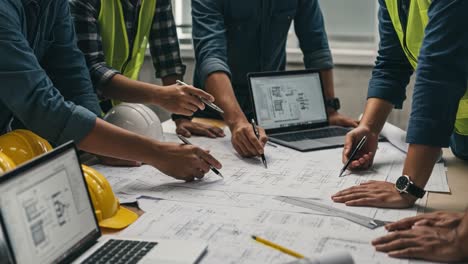 collaborative construction planning: a team strategizes over architectural drawings and engineering designs in a busy project meeting environment