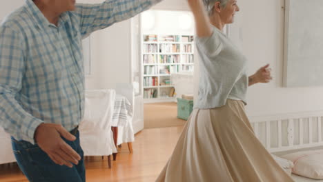 Retirement-couple-dancing-in-home-with-happiness