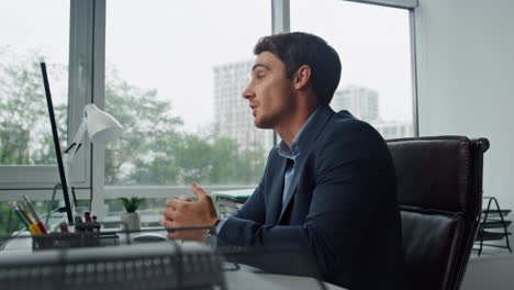 Handsome-freelancer-talking-online-at-remote-workplace.-Office-manager-calling