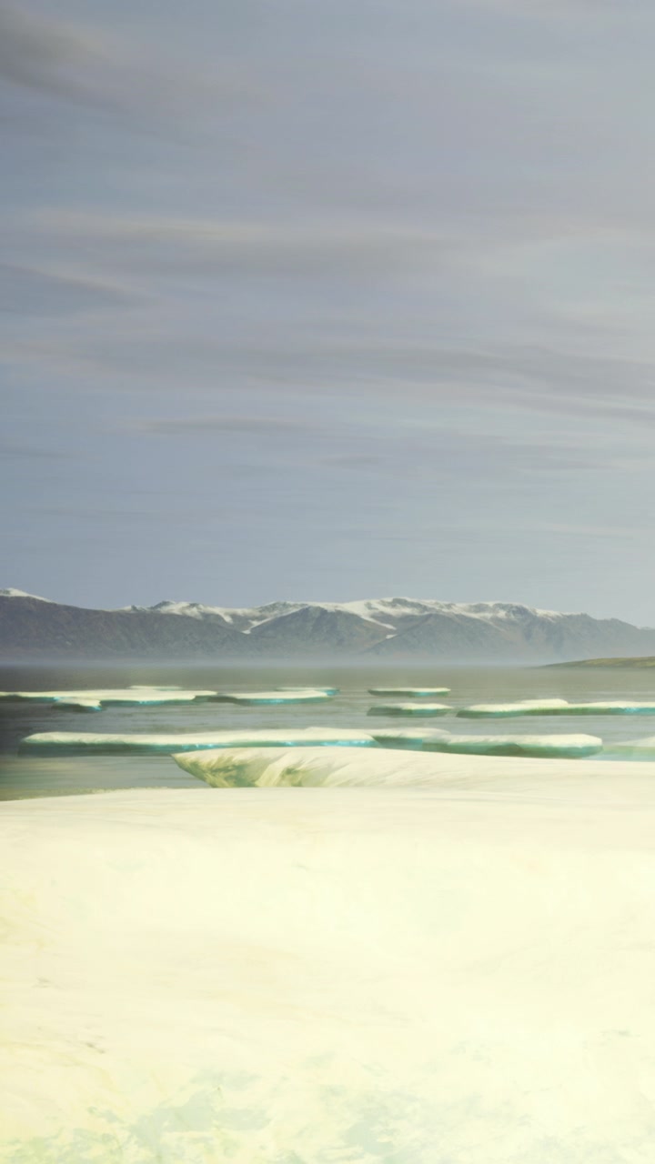 View of ocean and mountains during the day with waves in the foreground