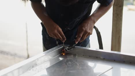 close-up of a person performing welding on a metal surface