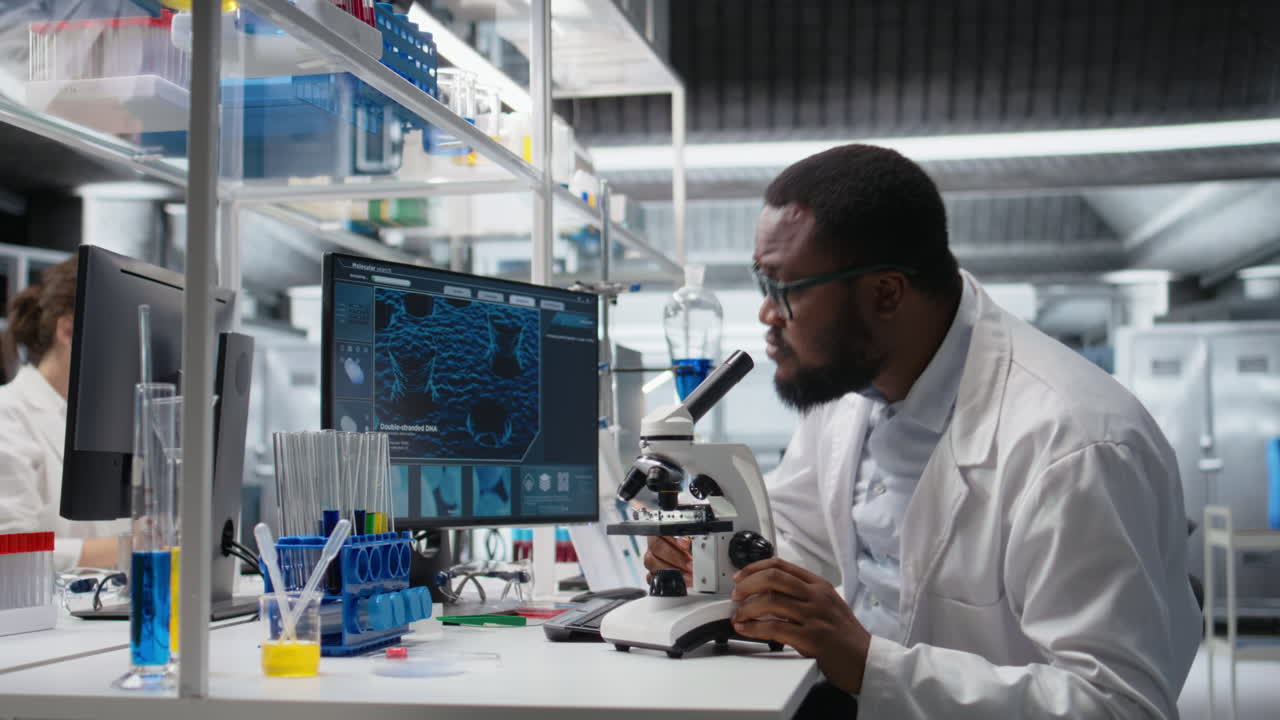 Vertical video Clinical microbiologist uses microscope for sample observation using PC software