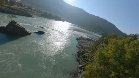 aerial panorama view speed water flow mountain river cliff rocky texture island and walking bridge