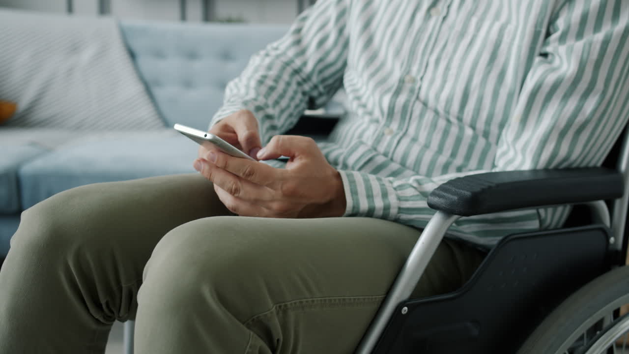 Man in a wheelchair using a smartphone