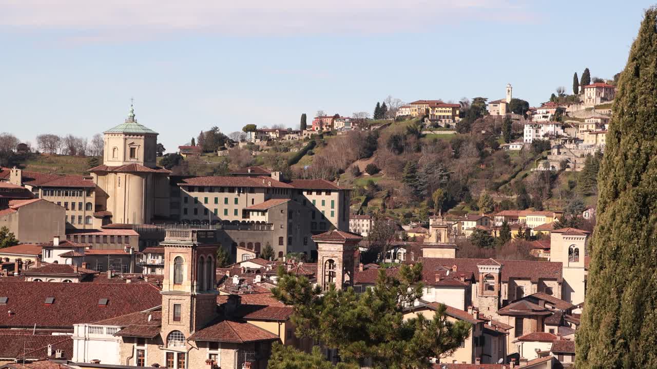 Italy Bergamo's medieval upper city, showcasing its unique architecture and expansive urban skyline under a clear, bright sky