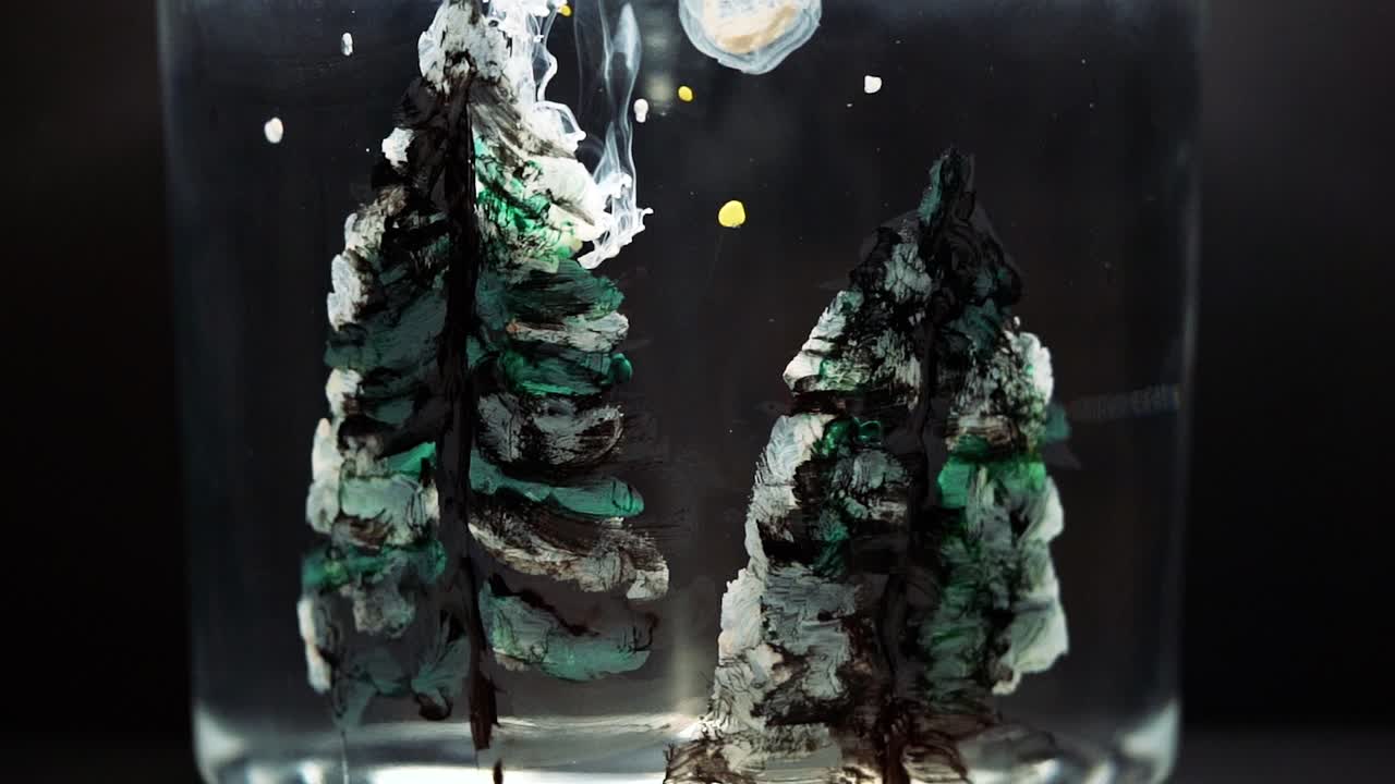 White paint floating in water tank with pine tree drawing inside. Stable shot with the Sony a7iii.