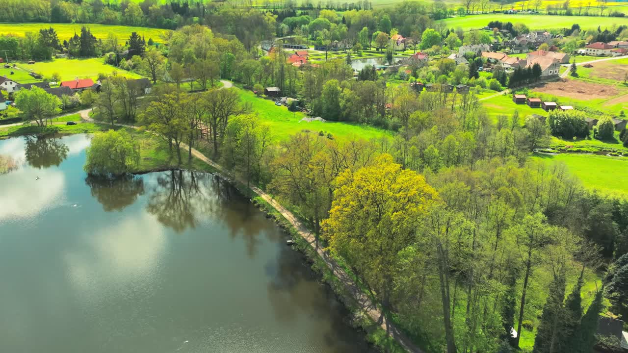 Aerial Tracks Bohemian Bird fly above Czech Republic Rural Farmland Lake Village Drone View