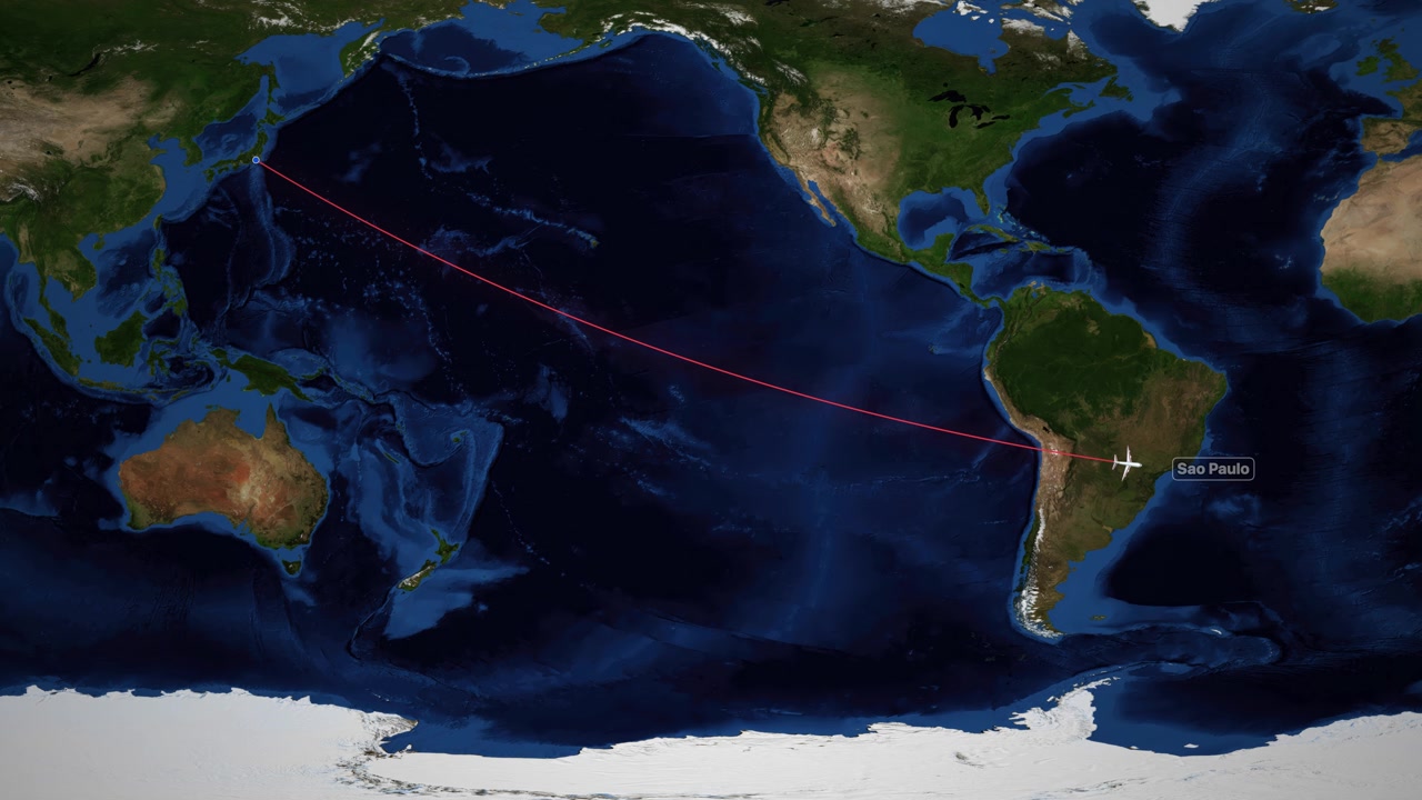 A digital world map tracks an airplane flying from Tokyo to Sao Paulo across oceans