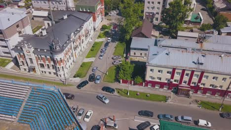 newlywed couple walks along beautiful building bird eye view