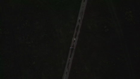 aerial, dark and walking people on road
