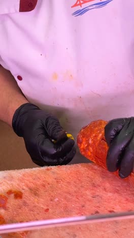 a butcher preparing meat on a cutting board