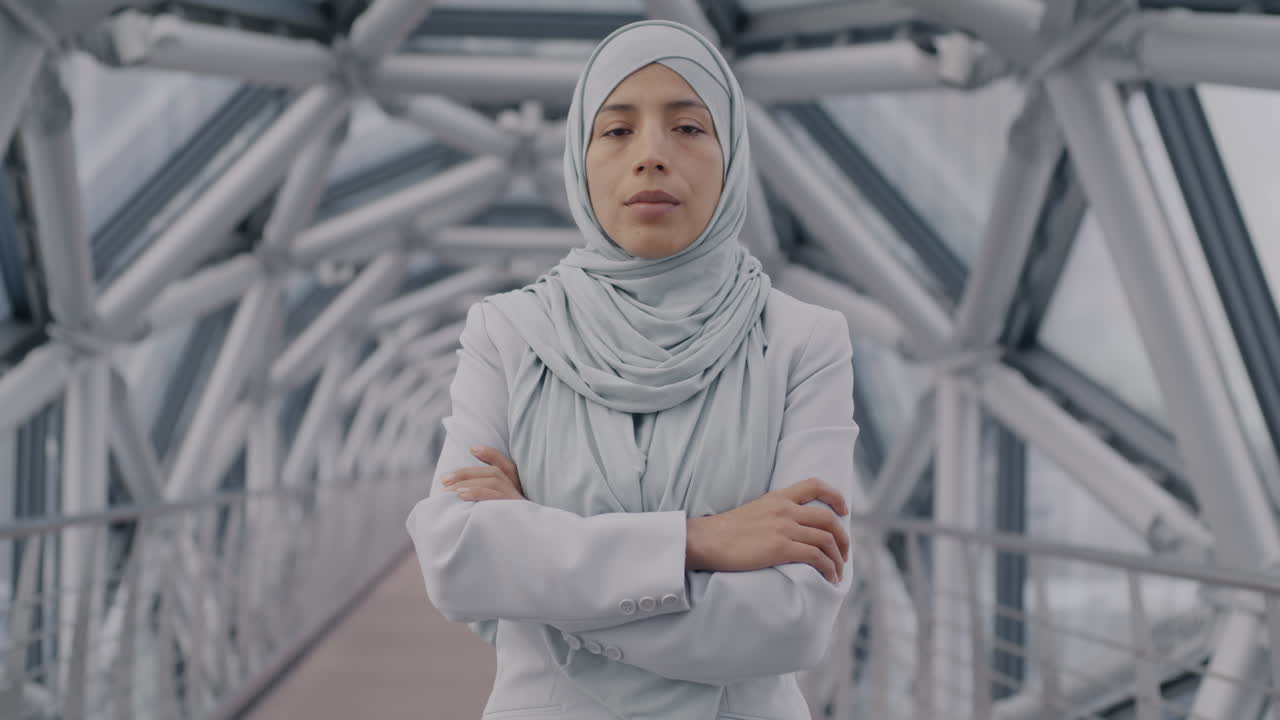 Woman in Hijab on a Modern Bridge