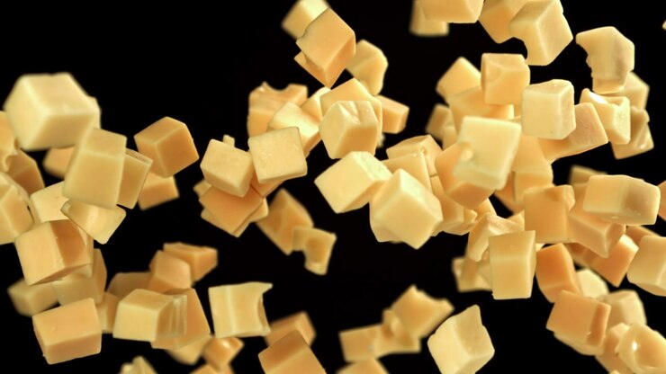 Cheese Cubes Falling in Super Slow Motion on Black Background