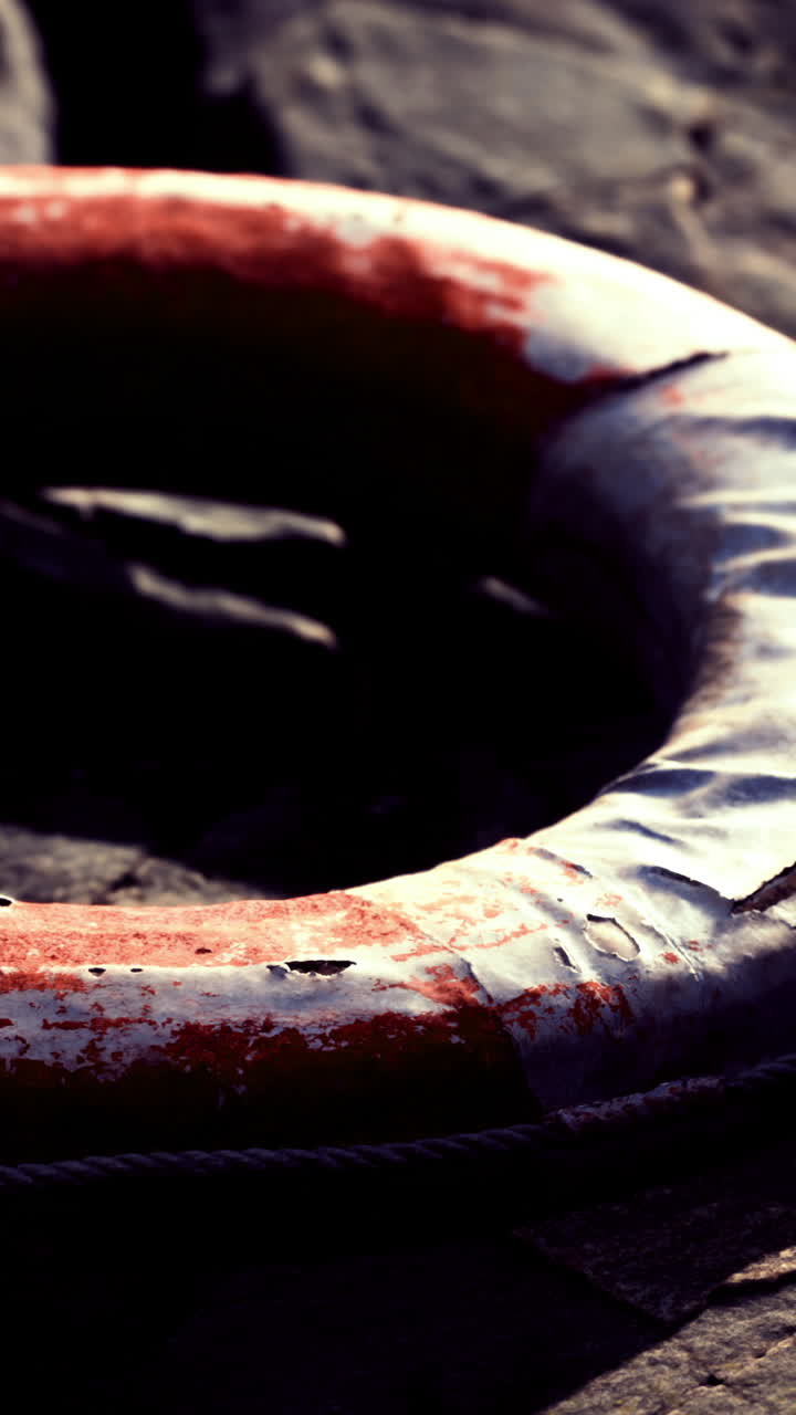 Lifebuoy resting on the beach sand during evening light