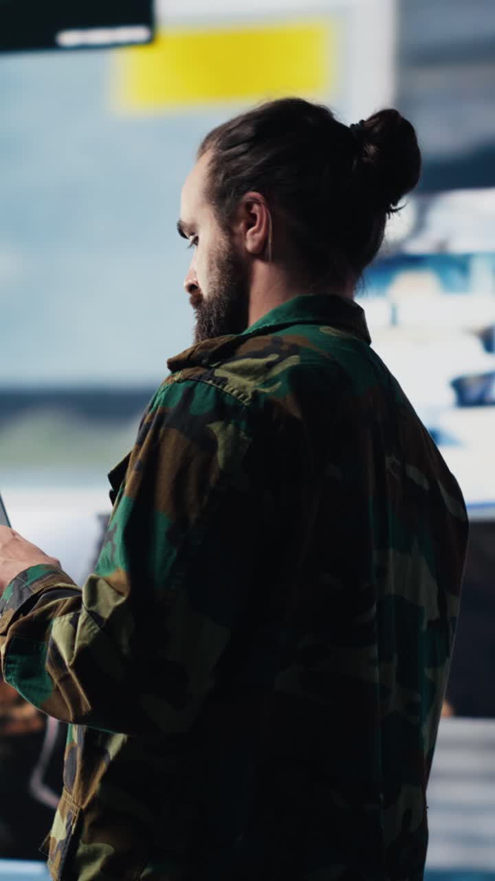 Vertical Video Armed forces soldier gathers surveillance from digital drone systems