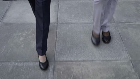 Legs-of-businesswomen-walking-on-street