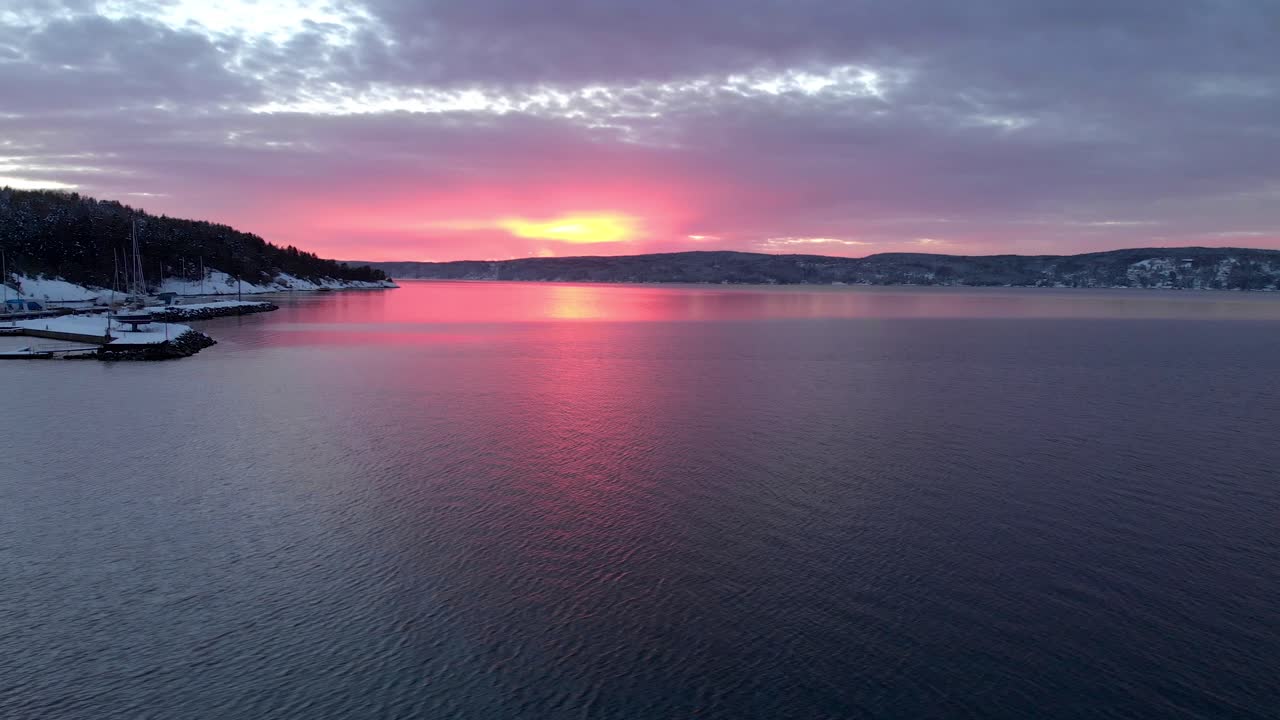 Aerial evening shot of Norwegian fjord with red sky
