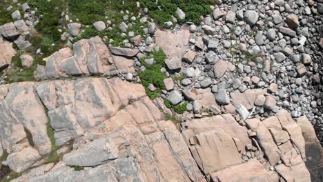 Top-down-view,-capturing-the-details-of-the-granite-stones-and-rocks-at-the-shore-of-Bohuslan,-West-Sweden