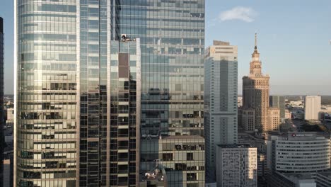 Modern-skyscrapers-and-Palace-of-Culture-and-Science-in-Warsaw,-Poland,-aerial-view