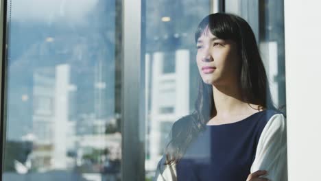 Young-woman-looking-through-the-window