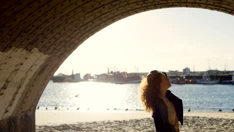 woman standing with hand on hair at dock 4k