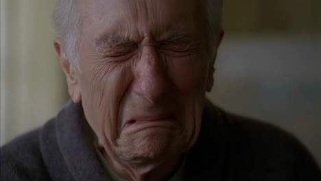 close-up of an elderly man crying in distress