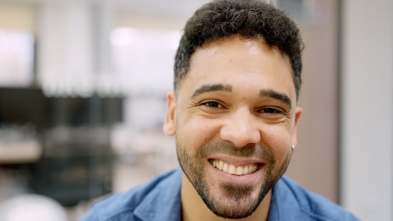 Hispanic man smiling at camera working in a coworking