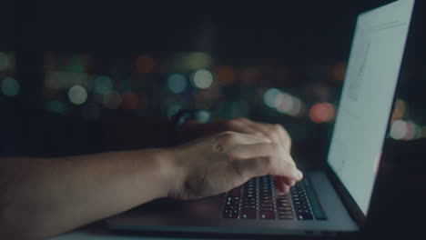 white mans hands typing text at night