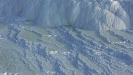 white travertine terraces or travertine pools that cascade down the hillside in pamukkale