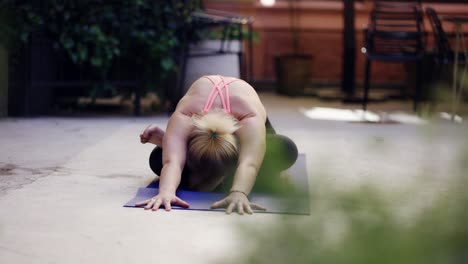 Yogi-woman-performing-bending-asana-outdoors