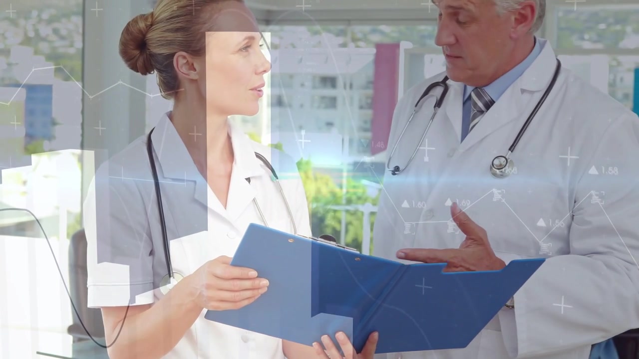 Woman MD opening blue folder checking chart, man MD gesturing as digital charts showing data
