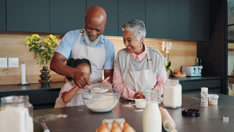 grandparents baking with their grandchild in the kitchen