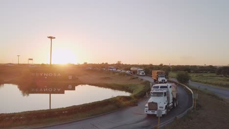 aerial - flowing traffic at sunrise in reynosa, mexico, wide rising shot