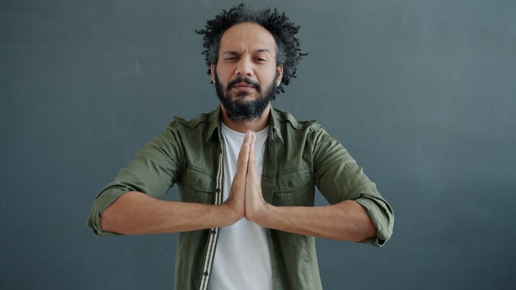 Man in prayerful meditation pose