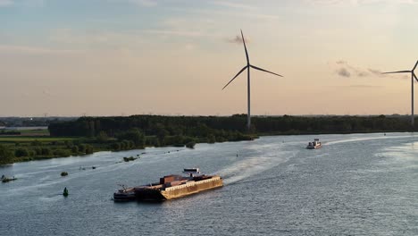 sunrise at barendrecht and on the oude maas river cargo is being delivered by boat