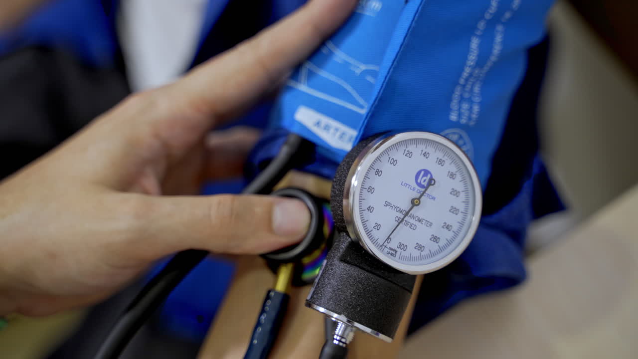 Measuring blood pressure at clinic front desk. Health care equipment. Consultation at clinic. Pressure measuring device. Selective focus on hand.