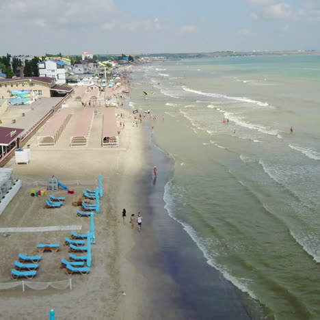 aerial view of beach with tourists, sunbeds and umbrellas at a luxury hotel. sea travel destination.