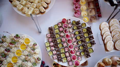 different pretty desserts on buffet tables, rising top down pull-out