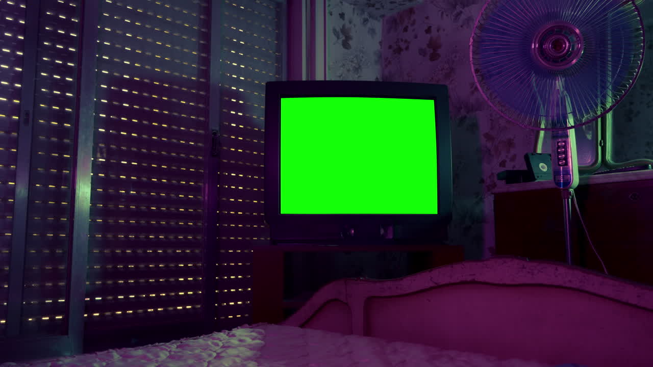 Retro CRT Television with Green Screen in a Dimly Lit Bedroom