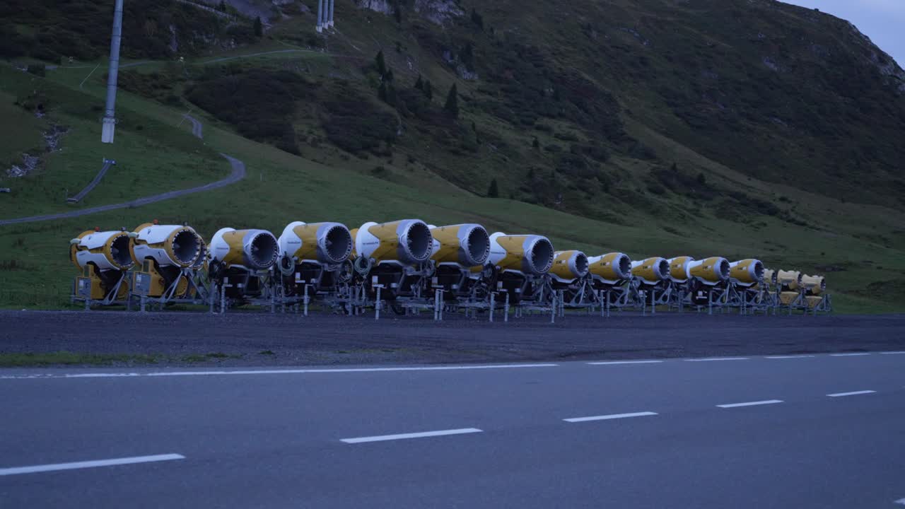 Aerial view of idle snow canons lined up along the alpine slope in Lech Zürs during late summer