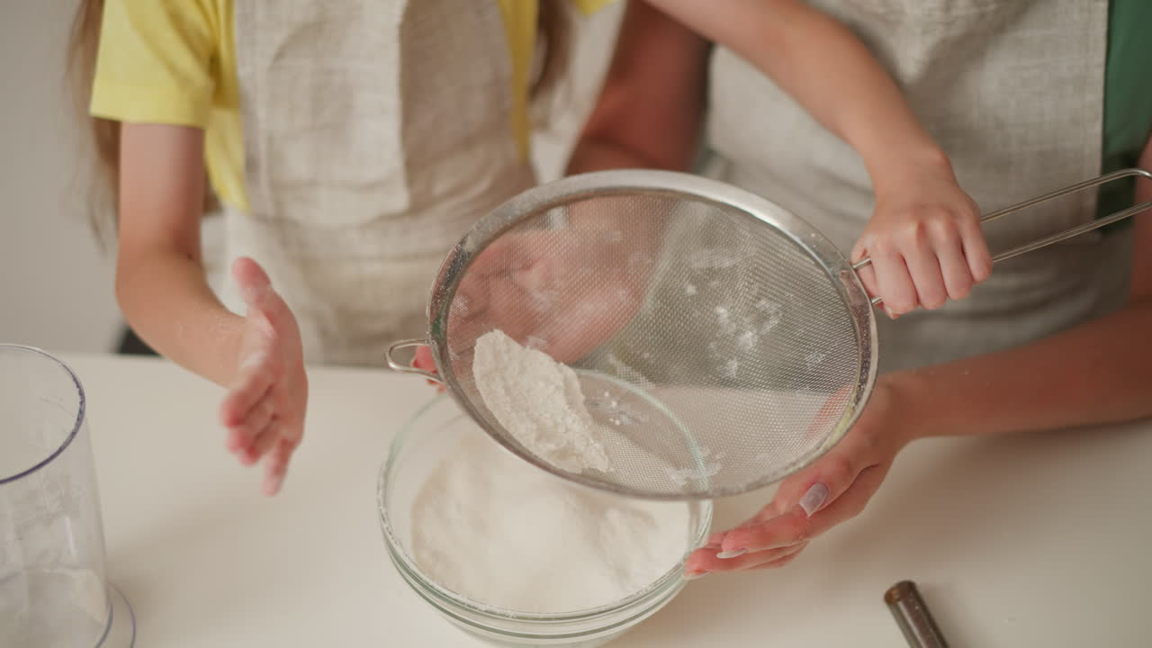 Child learning to bake with mother