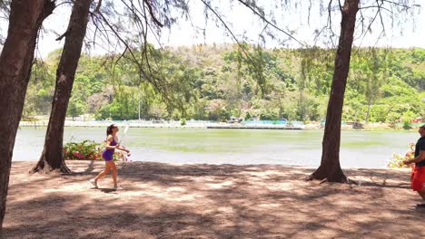couple playing badminton by the lake