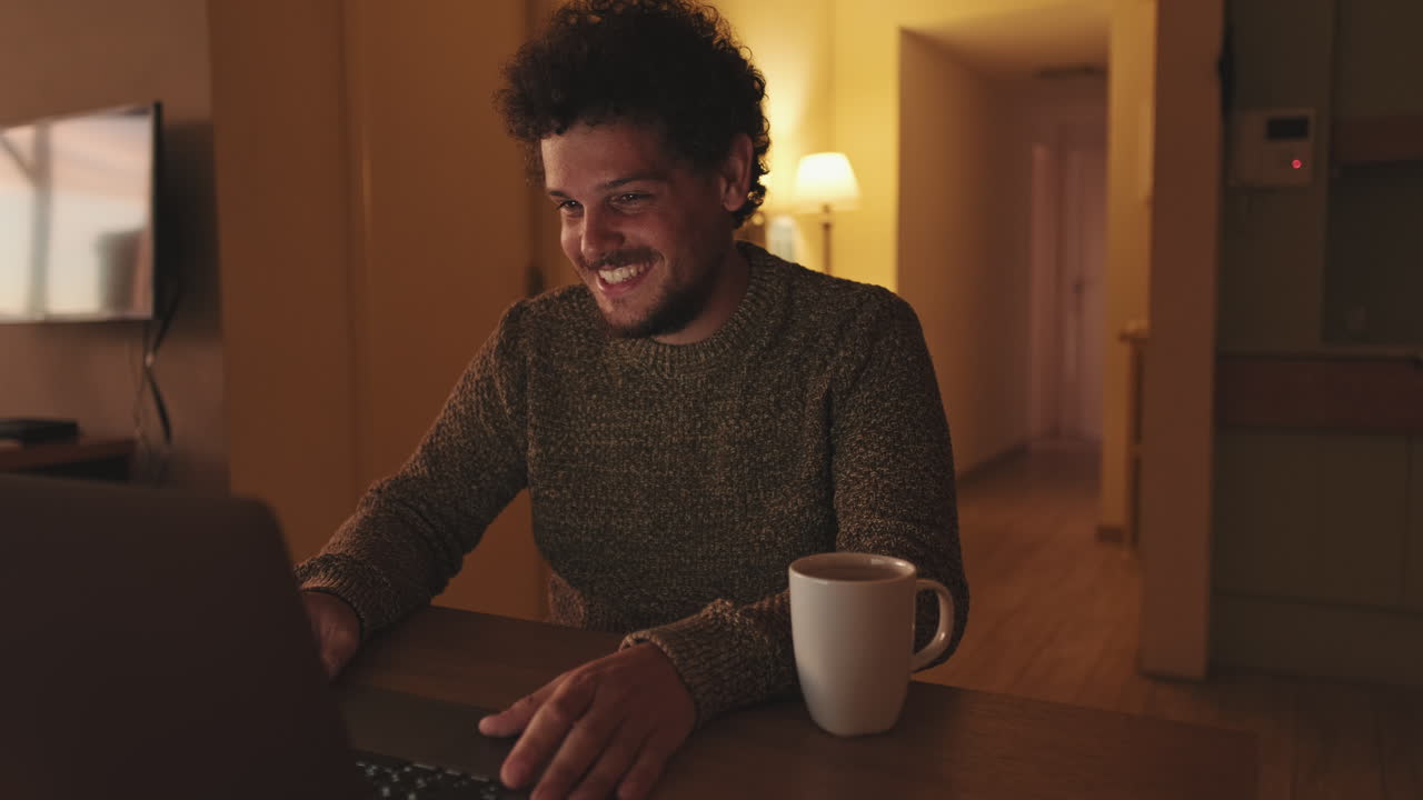 Man Using Laptop with Coffee