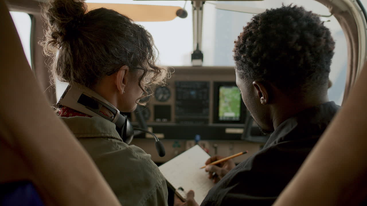 Pilots Discussing Navigation Screen during Flight Training Session