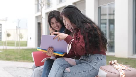 three asian girl students talking at break time sitting on campus