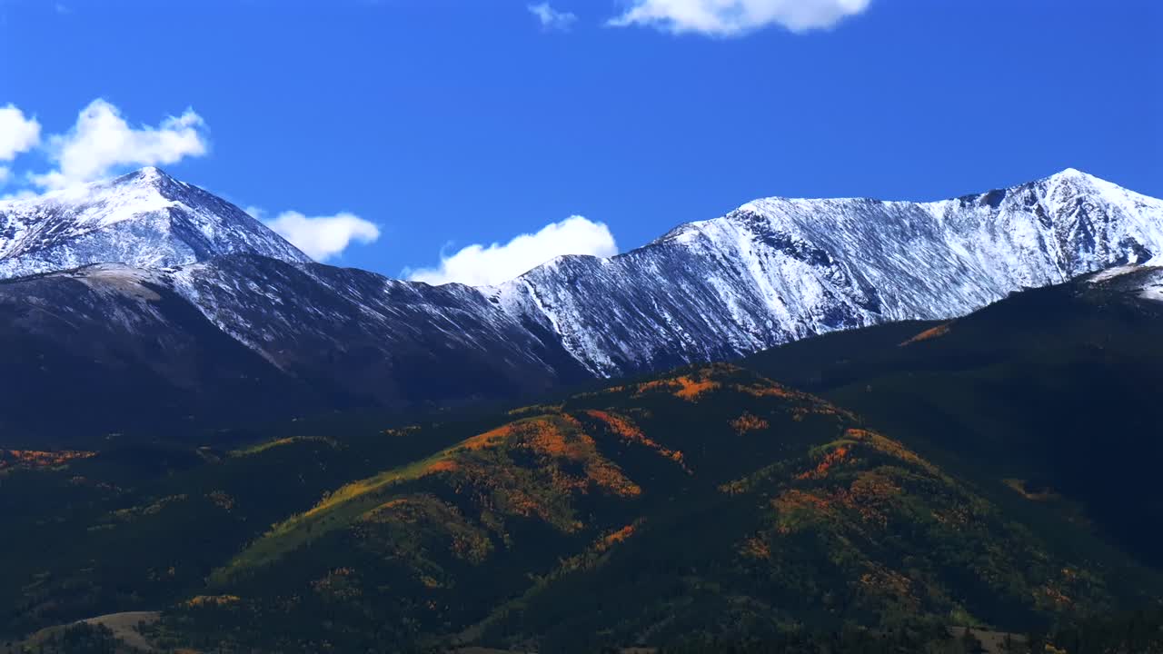 Mt Mount Shavano 14er Tabeguache Peak aerial drone down motion Colorado trail Sawatch Range fall autumn aspen trees San Isabel National Forest snow dusting morning vibrant blue sky clouds