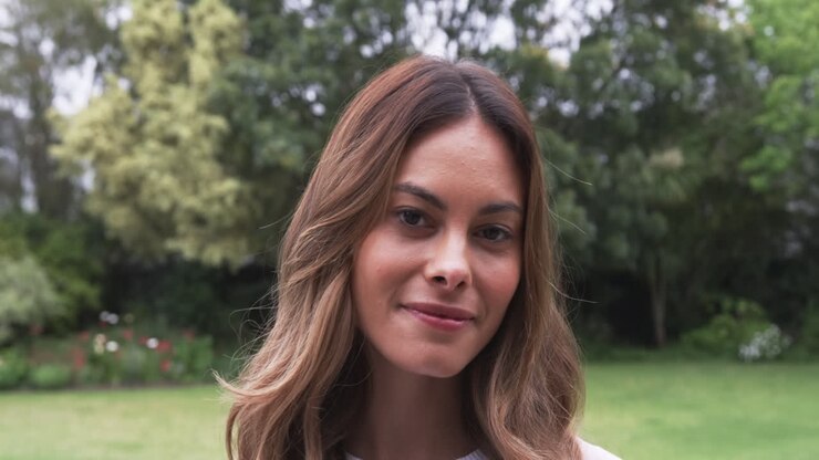 Portrait of smiling woman enjoying outdoor garden